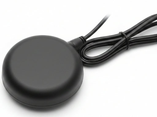 Black round wireless charging pad with a cable on a white background