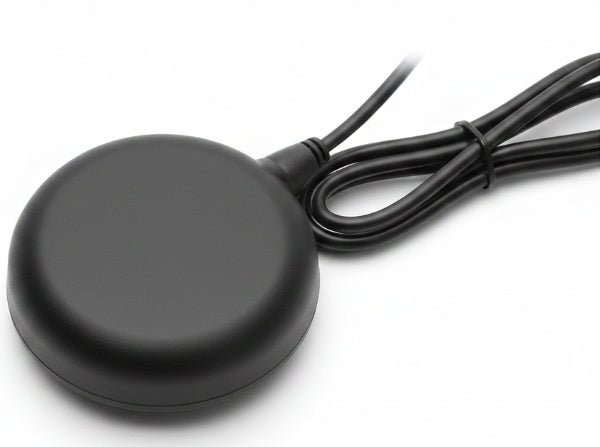Black round wireless charging pad with a cable on a white background