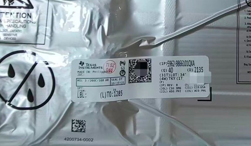 Close-up of a Texas Instruments component 5962-9866101QXA with labels and barcodes on a clear background