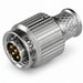 A metallic cylindrical connector with a ribbed body and a multi-pin round plug end, shown on a plain white background.