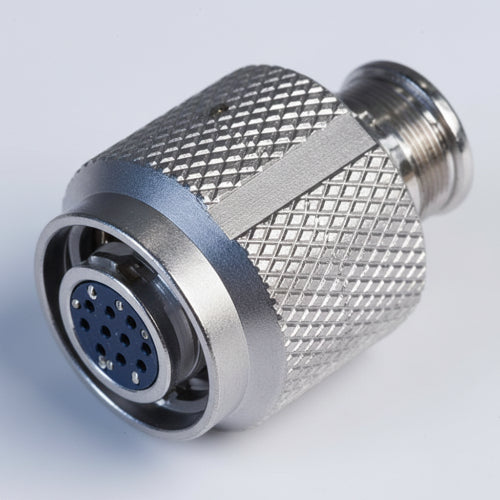 A metallic silver male-to-female adapter connector with a knurled textured body and a 9-pin circular plug insert, shown on a plain white background.