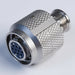 A metallic silver male-to-female adapter connector with a knurled textured body and a 9-pin circular plug insert, shown on a plain white background.