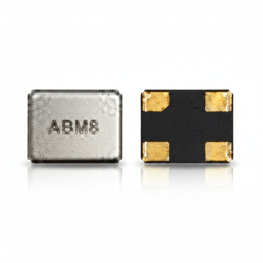 Two small electronic components on a white background: a silver rectangular chip with the text 'ADM8' and a black square component with four gold pads.