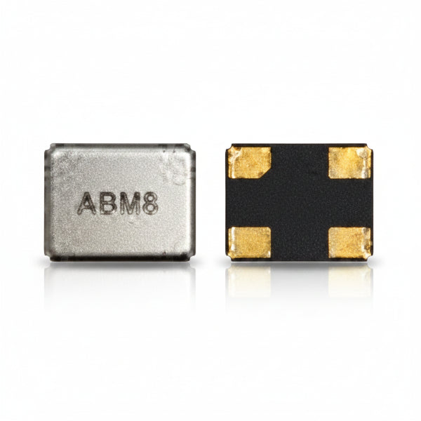 Two small electronic components on a white background: a silver rectangular chip with the text 'ADM8' and a black square component with four gold pads.