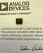 Analog Devices certificate of compliance with a small electronic component on a gray background