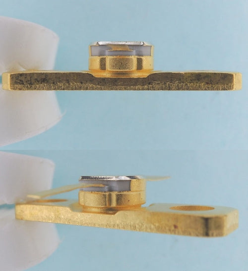 Two gold metal washers on a light blue background