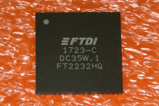 An FTDI 1723-C DC35W.1 FT2232HQ electronic chip on a textured orange background.