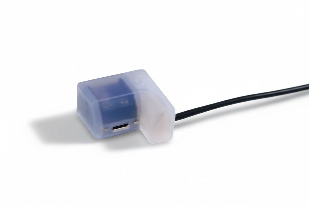 Small electronic component with blue light on a white background