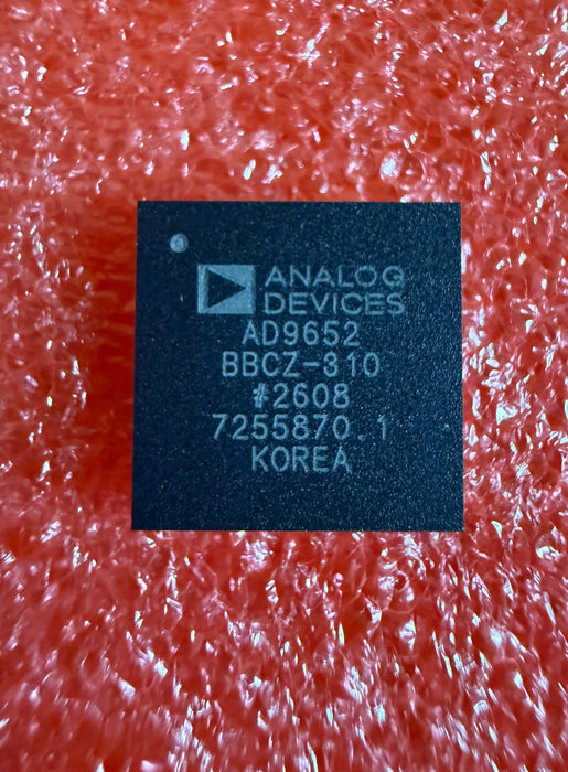 Analog Devices AD9652 BBCZ-910 integrated circuit chip on textured red foam packaging.