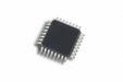Small electronic chip with metallic legs on a white background
