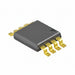 A small rectangular electronic component with a dark gray body and bright yellow-green pins, shown on a plain white background.
