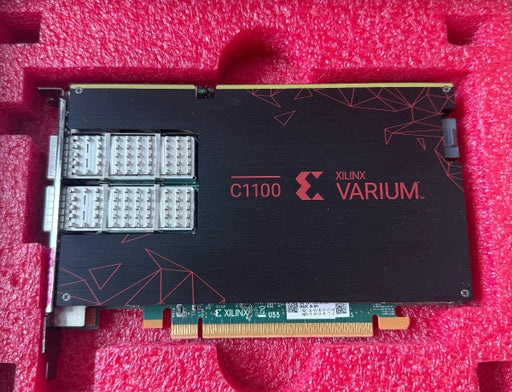 A Xilinx Varium C1100 PCIe card shown inside its pink foam packaging insert, featuring a black metal housing with red branding and multiple silver connector pins.